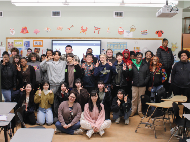 Students of American and Japanese heritage gathered around in a group photo